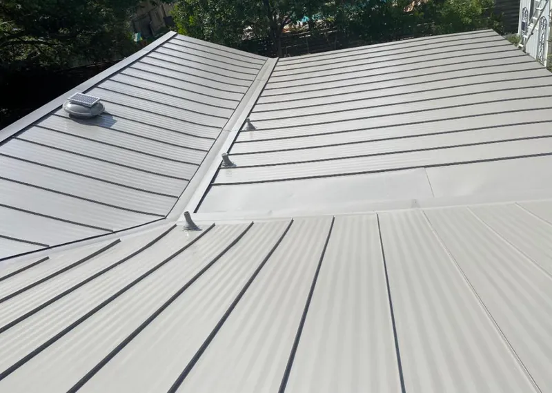Solar attic fan installed on a metal roof for Roof Ventilation in Woodland Park